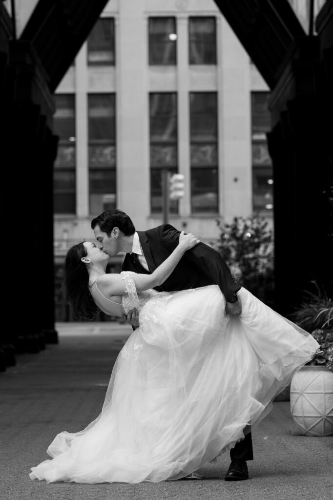 Wedding couple kissing in front of Shinola Hotel