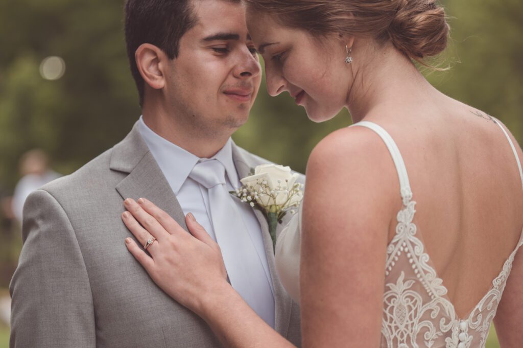 Image of a couple close to each other on their wedding day taken by a wedding photographer.