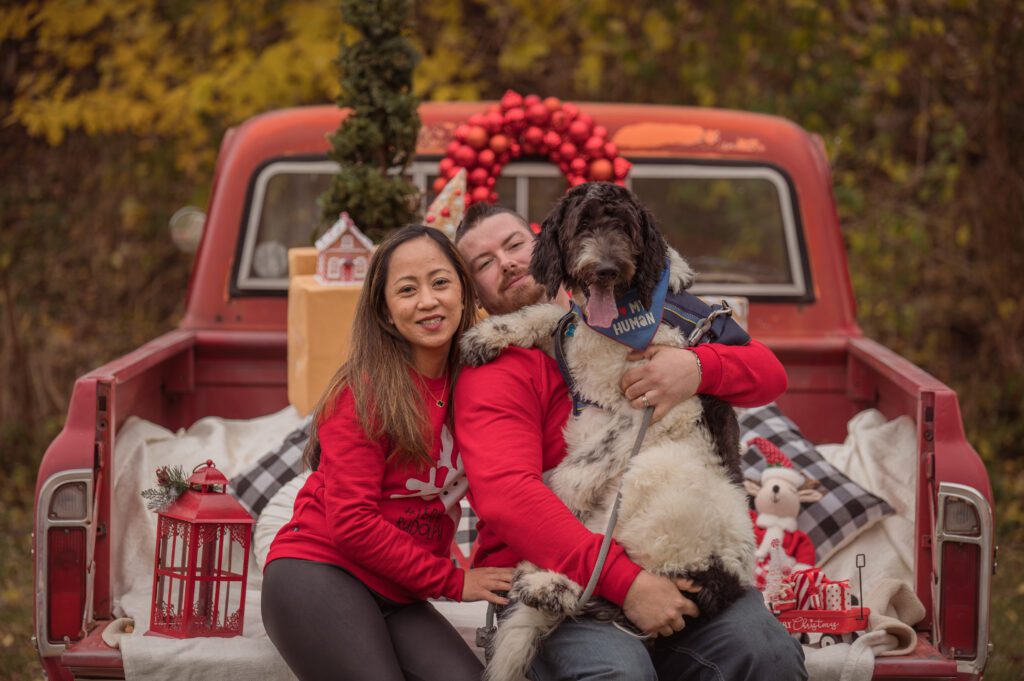 Family Photo on a Red Truck, at their Holiday Mini Sessions. 