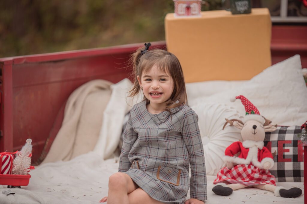Photo of a baby girl on a Red Truck Mini Session. 